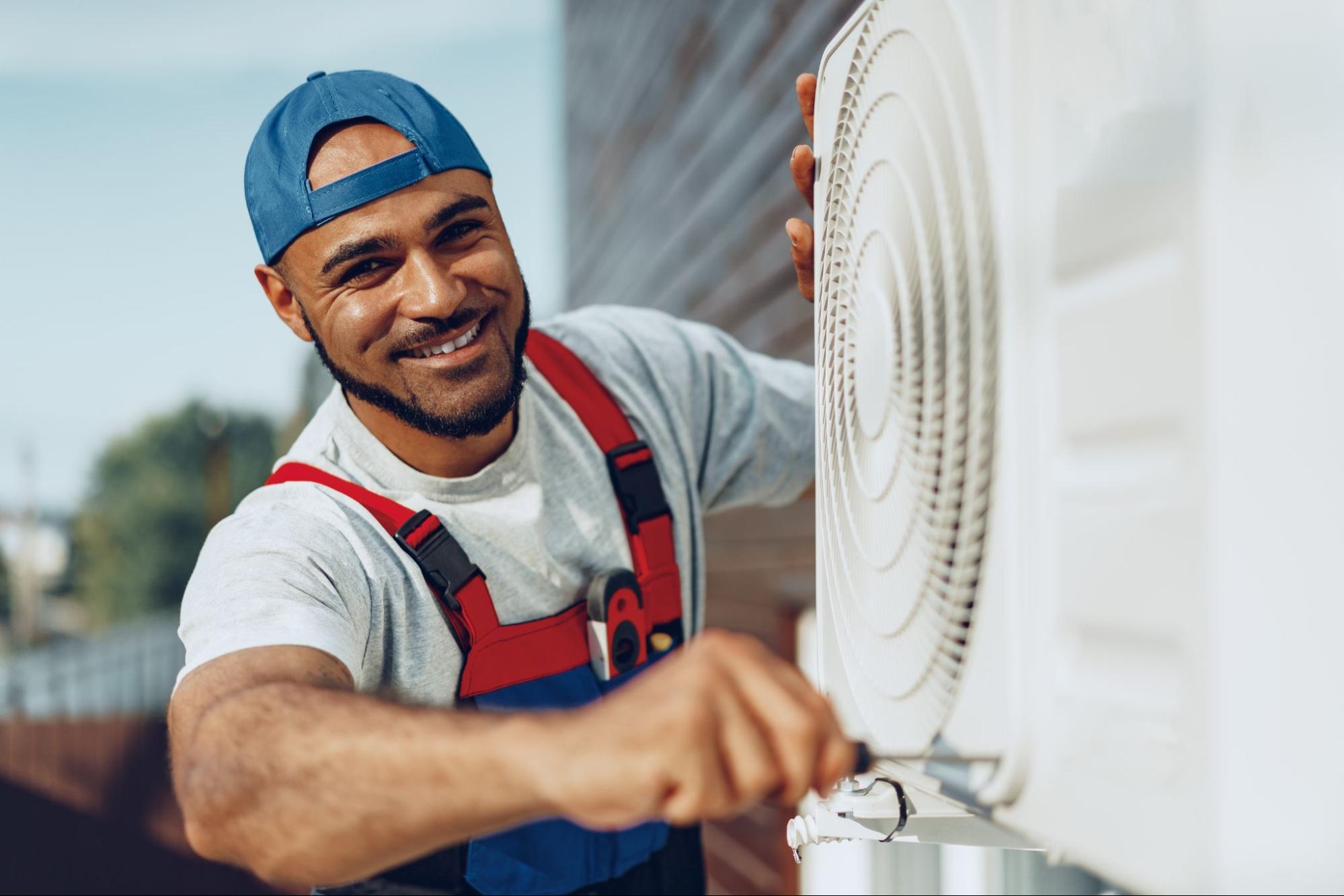 Man working on an air conditioning unit.