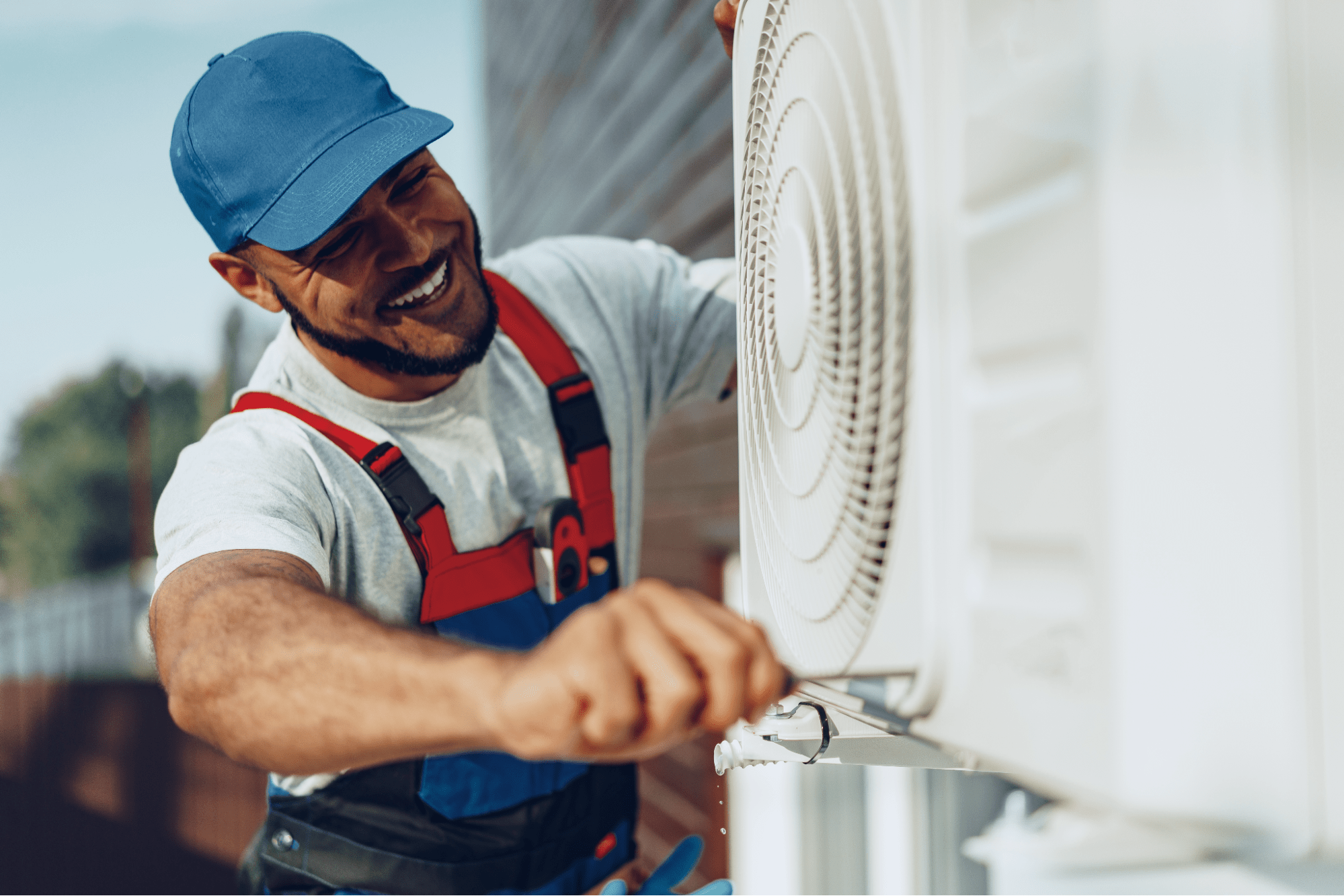 A man repairing an AC unit.