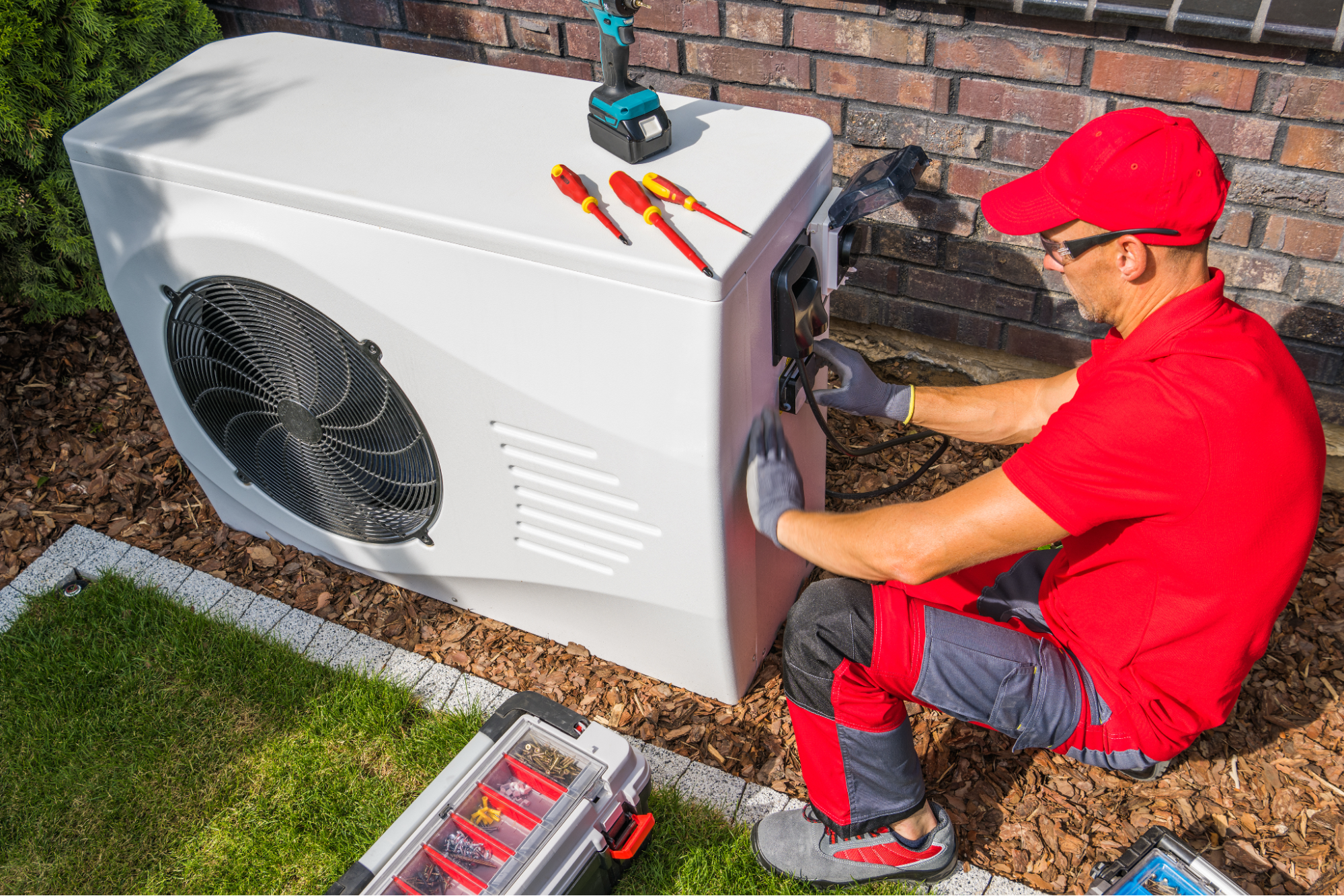 A man repairing a heat pump